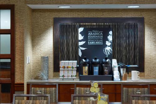 a bar with bottles of alcohol on a counter at Courtyard by Marriott Bloomington Mall of America in Bloomington