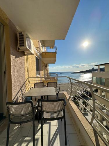 a balcony with a table and chairs on a building at Eri Apartments 4 in Shëngjin