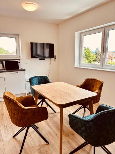 a dining room with a table and chairs at Swiss City Apartments Rust in Rust
