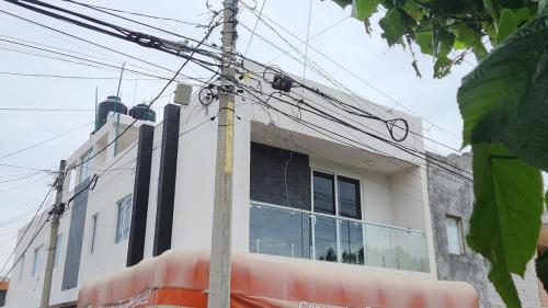 a pole with wires in front of a building at Departamento Garcis in Morelia