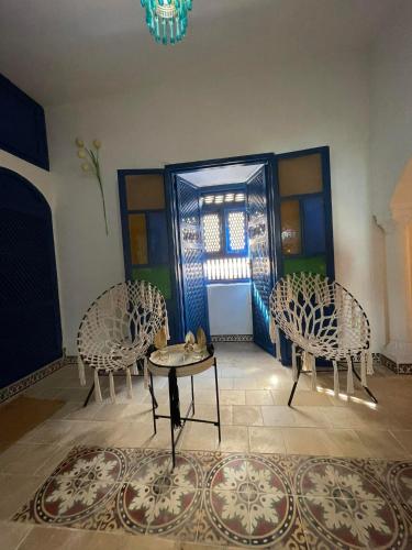 a room with chairs and a table and a window at Dar Sandra Bizerte in Bizerte