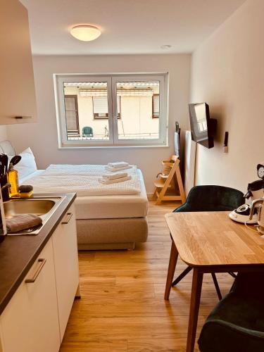 a small room with a bed and a window at Swiss City Apartments Rust in Rust