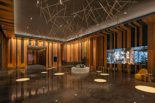 a lobby with a table and chairs and a television at W Taipei in Taipei