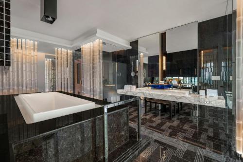 a bathroom with a tub and a sink at W Taipei in Taipei