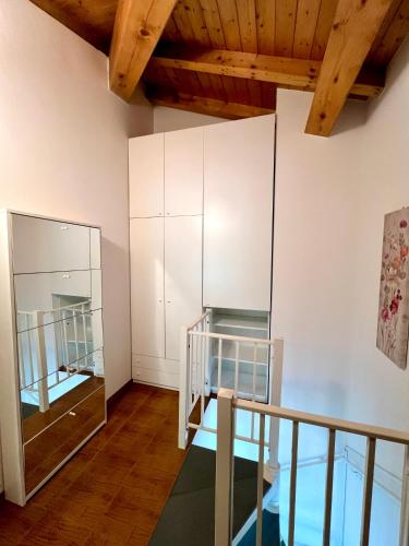 a room with a staircase and a mirror at CROSINA HOLIDAY - Casa Lucia in Ledro