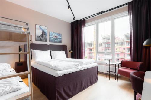 a bedroom with two bunk beds and a window at Scandic Sunnfjord Hotel & Spa in Førde