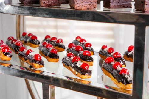 a group of desserts on a display case at Park Inn by Radisson Dubai Motor City in Dubai