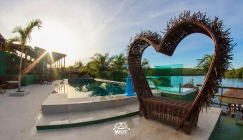 a heart shaped chair in the middle of a pool at Aconchego Matuto - Hotel Club e Restaurante in Canindé de São Francisco