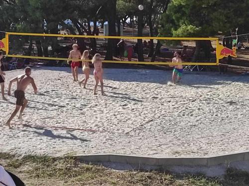 a group of people playing a game of volley ball at Apartmani Punta in Zadar