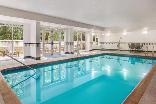 a swimming pool with blue water in a building at Fairfield Inn & Suites Jacksonville West/Chaffee Point in Jacksonville