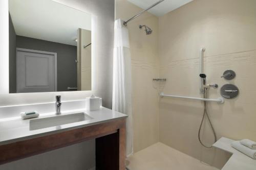 a bathroom with a sink and a shower at Residence Inn by Marriott Des Moines Downtown in Des Moines