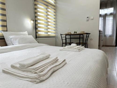 a white bed with white towels on top of it at Elden Bnb Xanthi in Xanthi