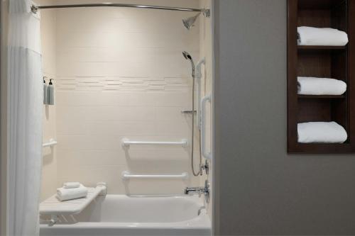 a bathroom with a sink and a shower with towels at Residence Inn by Marriott Des Moines Downtown in Des Moines