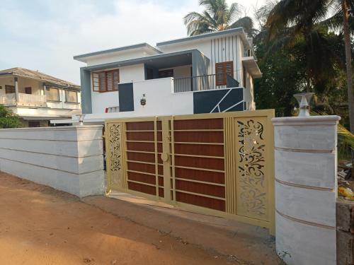 a house with a gate and a fence at La-Casona in Kottayam