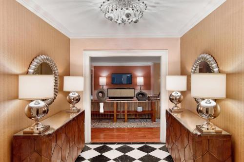 a living room with two lamps and a television at Sheraton New York Times Square Hotel in New York