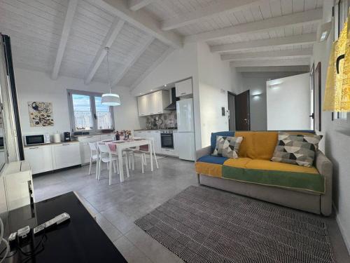a living room and kitchen with a couch and a table at Olimpia house, Quartucciu, South Sardinia, IUNT1079 in Quartucciu