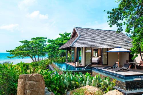 a villa with a swimming pool next to the ocean at Vana Belle, A Luxury Collection Resort, Koh Samui in Chaweng Noi Beach