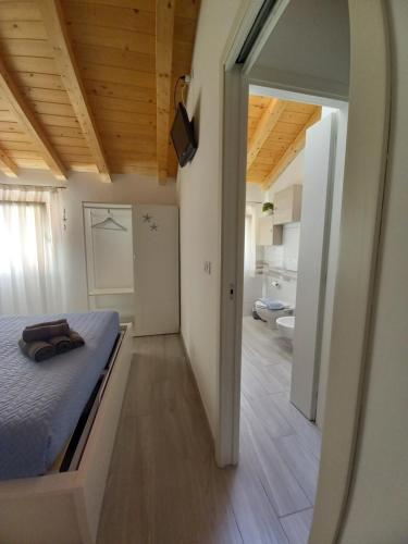 a bedroom with a bed and a room with a bathroom at Cas'Ale in Chioggia