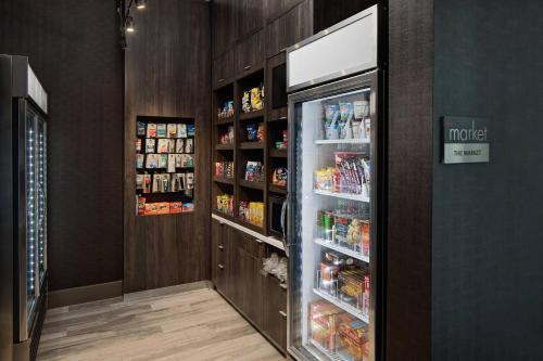 a refrigerator with its door open in a store at Courtyard by Marriott Dallas Downtown/Reunion District in Dallas