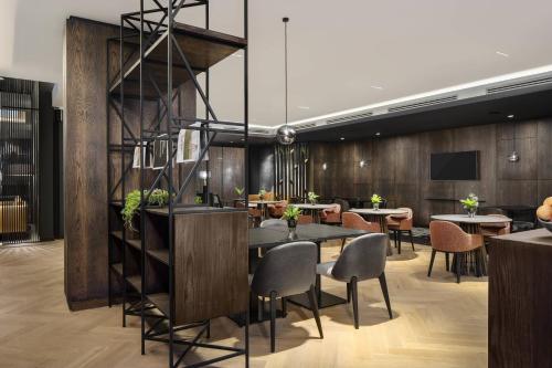 a dining room with a table and chairs at Johannesburg Marriott Hotel Melrose Arch in Johannesburg