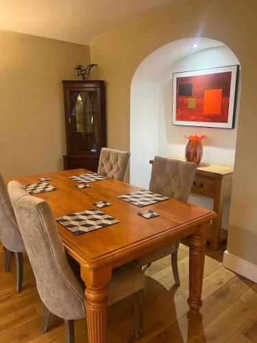 a dining room with a wooden table and chairs at Self catering apartment Silvermines in Nenagh