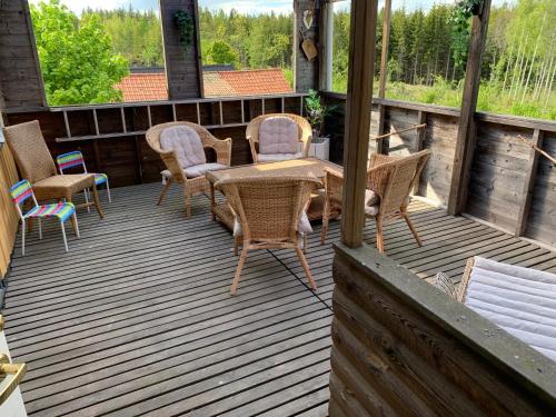 a deck with a table and chairs on it at Vandrarhem Solgården in Blackstad
