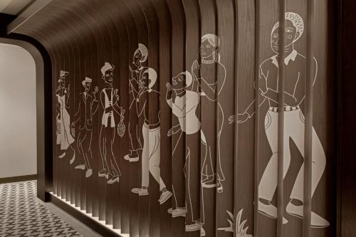 a wall mural of a group of men at Madi Paidi Bangkok, Autograph Collection in Bangkok