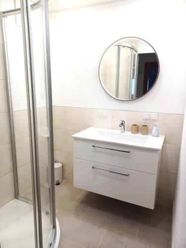 a bathroom with a white sink and a mirror at Appartementhaus Fritz-Rosenkranz in Mariapfarr