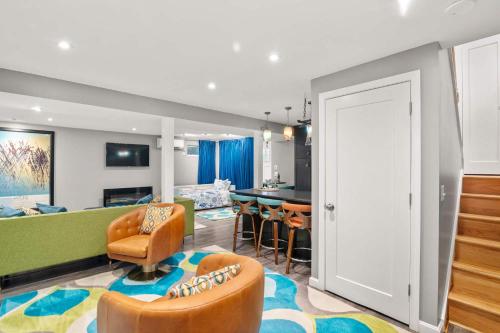 a living room with a couch and chairs and a table at Walk to Water-Dazzling Sunsets on the Bay in Truro