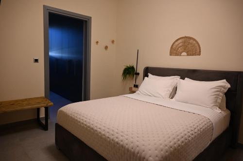 a bedroom with a large bed and a blue door at George's Soul in Porto Heli