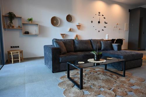 a living room with a couch and a table at George's Soul in Porto Heli
