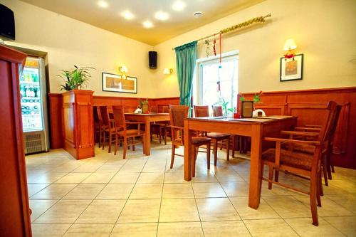 a dining room with wooden tables and chairs at Hotel Korona in Słubice