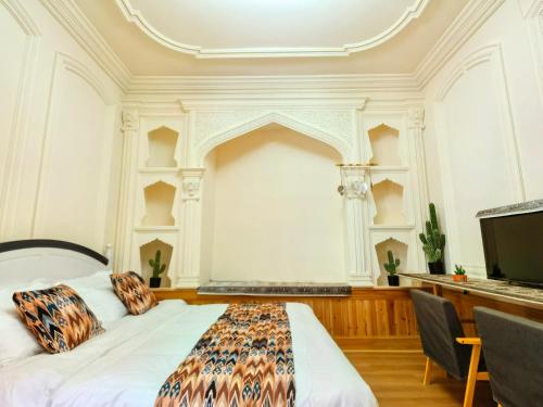 Ein Bett oder Betten in einem Zimmer der Unterkunft Xinjiang Rhythm Hotel-疆韵民宿