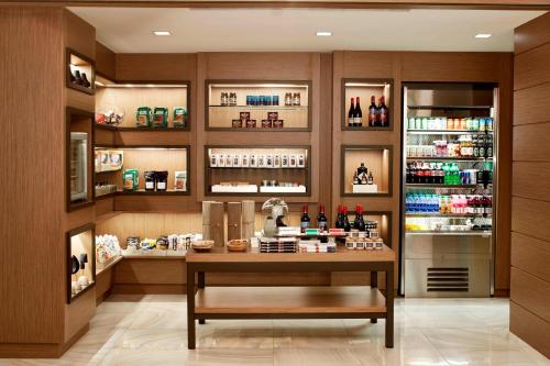 a room with a liquor store with a table and shelves at AC Hotel Atlanta Downtown in Atlanta