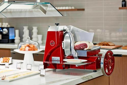a red mixer sitting on a counter with food at AC Hotel Atlanta Downtown in Atlanta