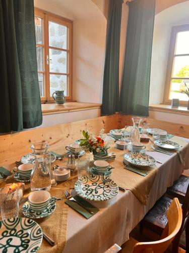 a long table with plates and dishes on it at Bio-Hof Lexmühle in Hammern
