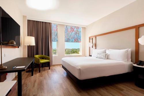 a hotel room with a bed and a desk and window at Fairfield Inn & Suites by Marriott Cancun Airport in Cancún
