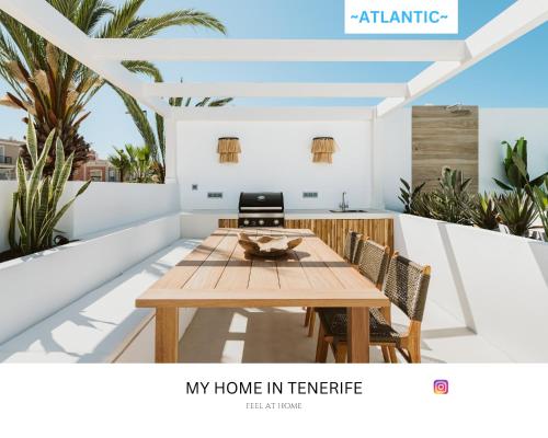 una imagen de un balcón con mesa y sillas en -ATLANTIC- by myhomeintenerife, Luxury Private heated pool, en Palm-mar