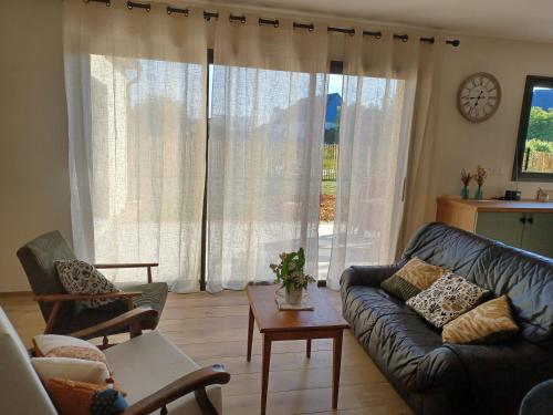 a living room with a couch and a table at Saint-Cast-Le-Guildo in Saint-Cast-le-Guildo