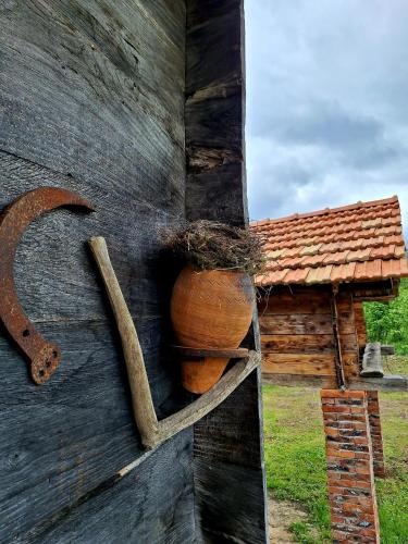a wooden door with a pot on the side of a building at Thea's Ethnographic Guest House in Nap'ich'khovo