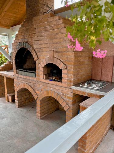 a brick pizza oven sitting on top of a patio at Escape in Dubova