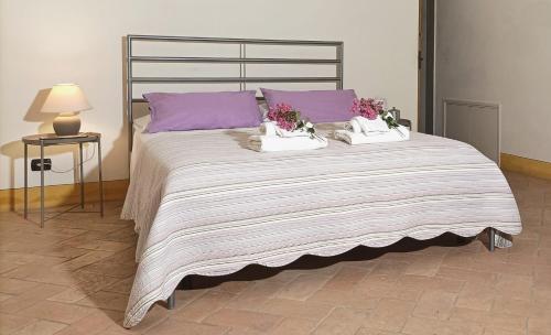 a large bed with two pillows on top of it at Home in Tuscany in Greve in Chianti