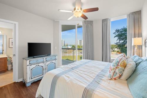 a bedroom with a bed and a flat screen tv at Silver Shells in Destin