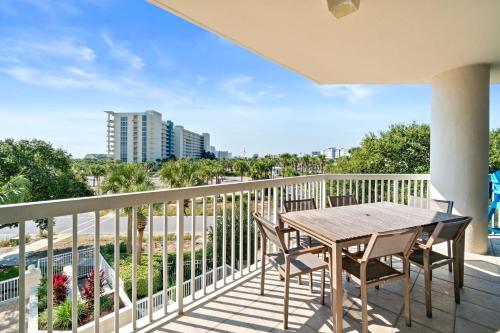 a balcony with a table and chairs and a view of the beach at Silver Shells in Destin
