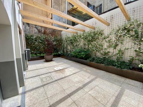 a courtyard with plants on the wall of a building at Zenone monolocale Reggio Emilia Historic Center in Reggio Emilia
