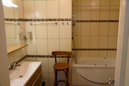 a bathroom with a tub and a toilet and a sink at Mimoza Apartment in Ðenovići