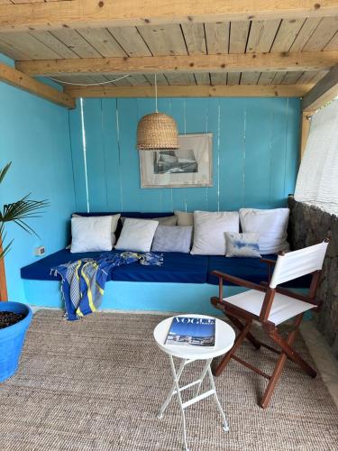 a blue bedroom with a bed and a chair at Blue Krk With Private Garden in Krk