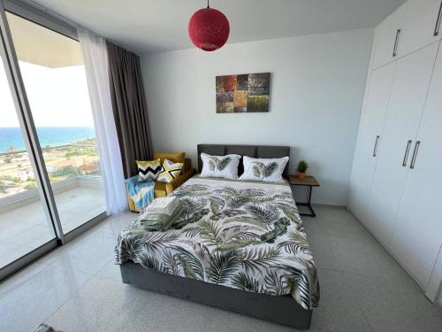 a bedroom with a bed and a large window at Studio sea view in Boğaz