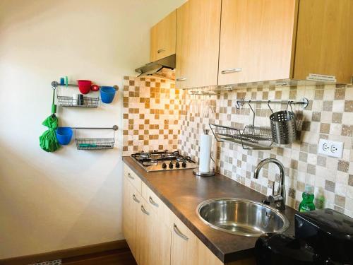a small kitchen with a sink and a stove at Paradera Palms 2 Bedroom in Paradera
