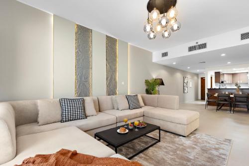 a living room with a couch and a table at Desert Key - Platinum Apartments in Gate Tower, Al Reem Island in Abu Dhabi